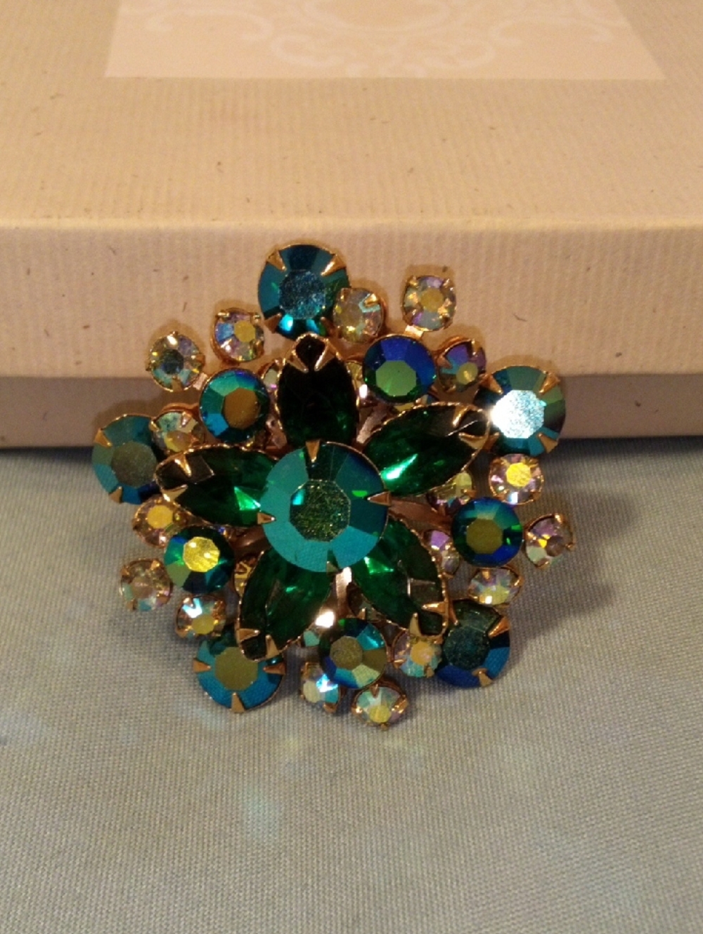 Gold-Tone Floral Brooch with Emerald and Teal Crystals